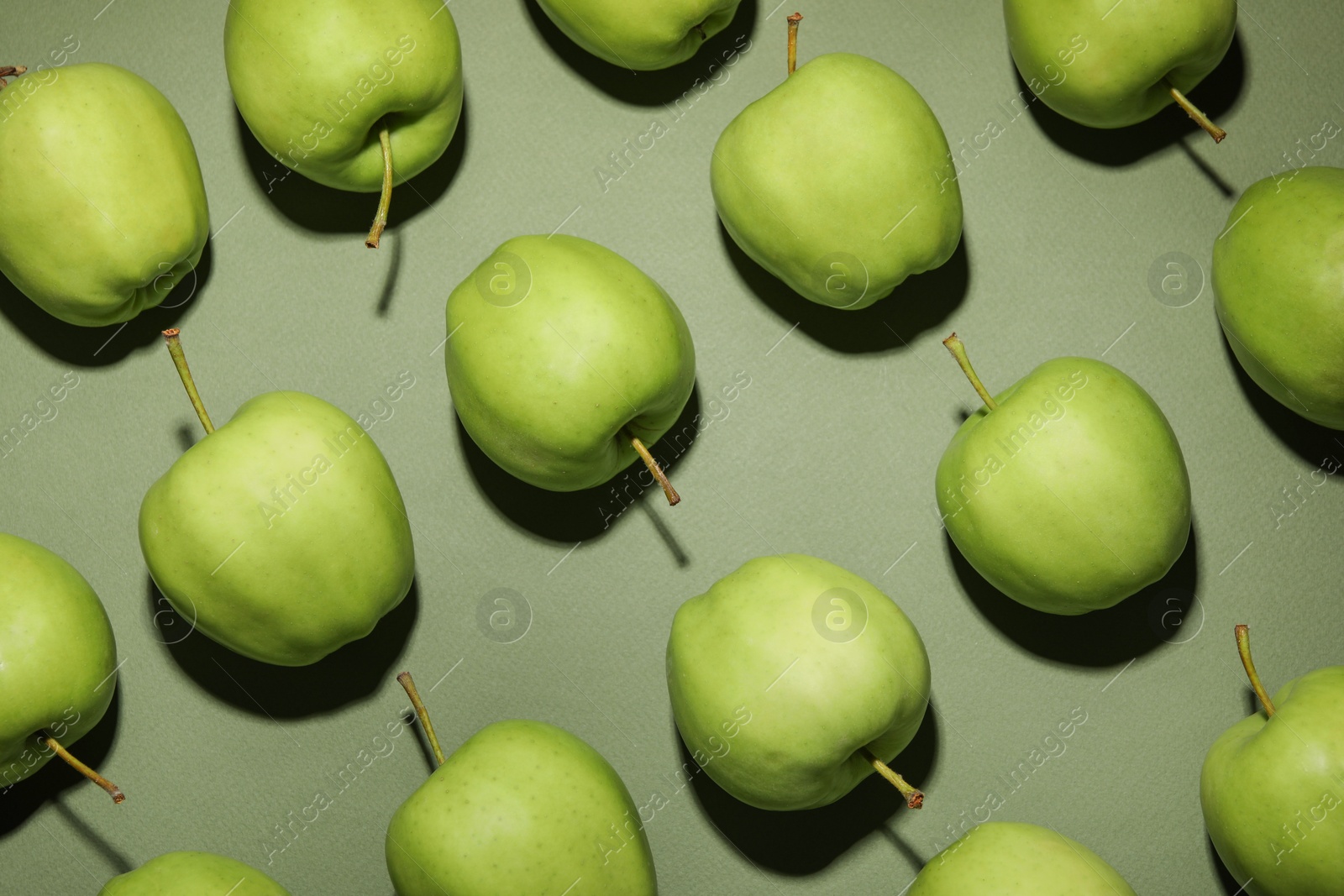 Photo of Tasty fresh apples on green background, flat lay