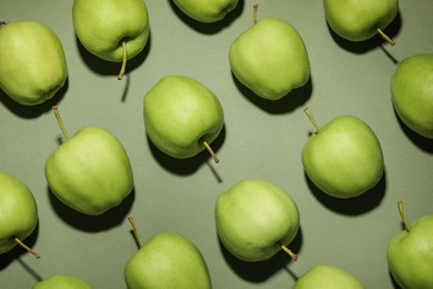 Photo of Tasty fresh apples on green background, flat lay