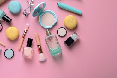 Flat lay composition with decorative cosmetics on color background