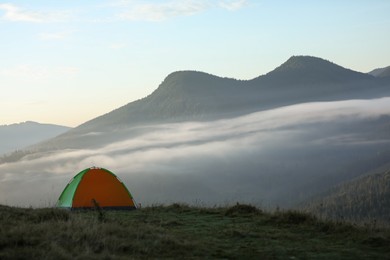 Photo of Camping tent in mountains on early morning