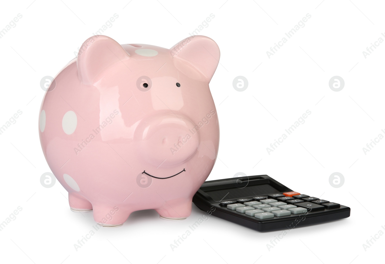 Photo of Piggy bank and calculator isolated on white