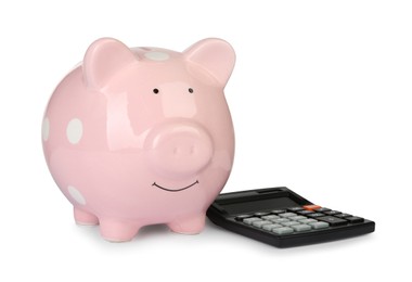 Photo of Piggy bank and calculator isolated on white