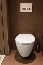 Photo of Beautiful bathroom with stylish toilet bowl in luxury hotel. Interior design
