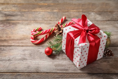 Beautiful composition with gift box and Christmas decorations on wooden table