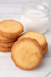 Photo of Tasty sweet sugar cookies on white wooden table, closeup