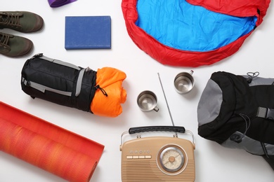 Photo of Flat lay composition with camping equipment on white background