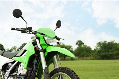 Photo of Stylish green cross motorcycle outdoors, space for text