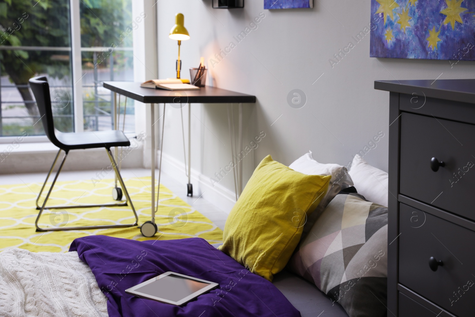 Photo of Modern teenager's room interior with comfortable bed, workplace and stylish design elements