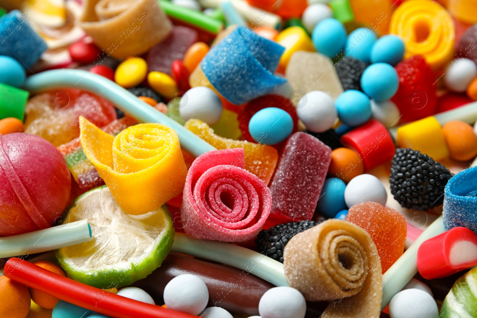 Photo of Many different yummy candies as background, closeup