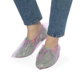 Photo of Woman wearing shoe covers onto her mules against white background, closeup