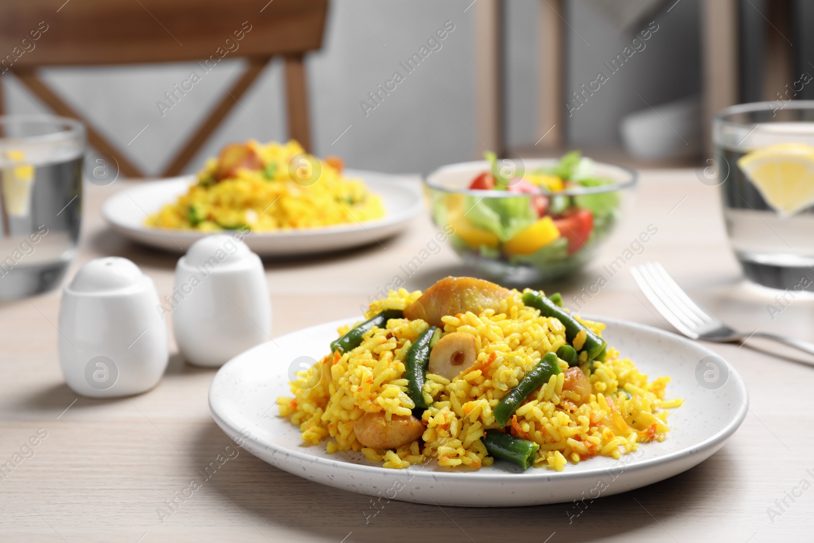 Photo of Delicious pilaf with chicken meat on white table