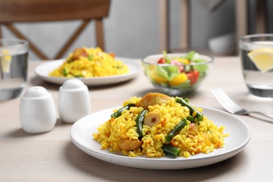 Delicious pilaf with chicken meat on white table