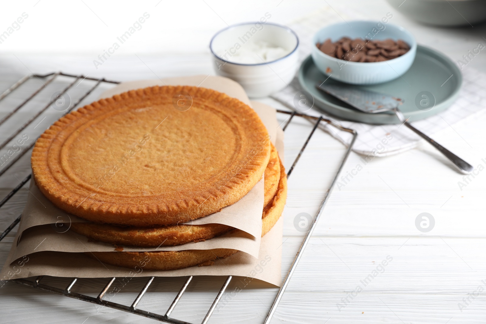 Photo of Ingredients for delicious homemade layer cake preparing on white wooden table