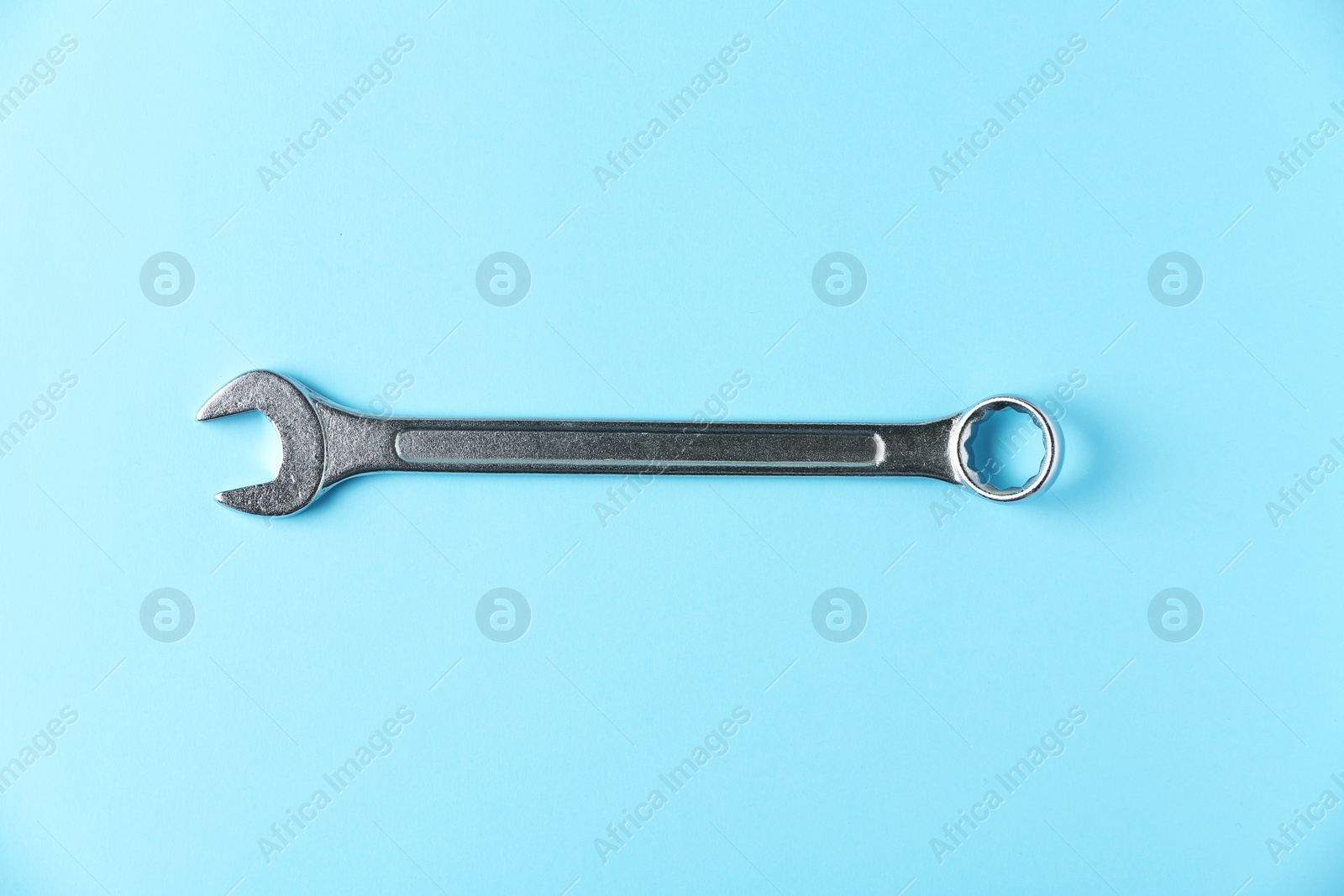 Photo of New wrench on color background, top view. Plumber tools