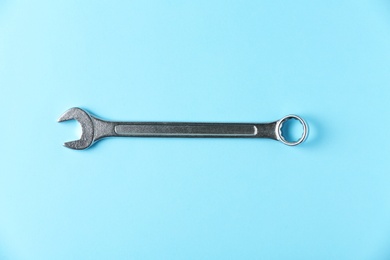 Photo of New wrench on color background, top view. Plumber tools