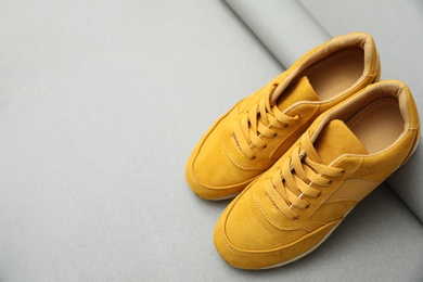 Image of Stylish yellow shoes on grey background. Footwear