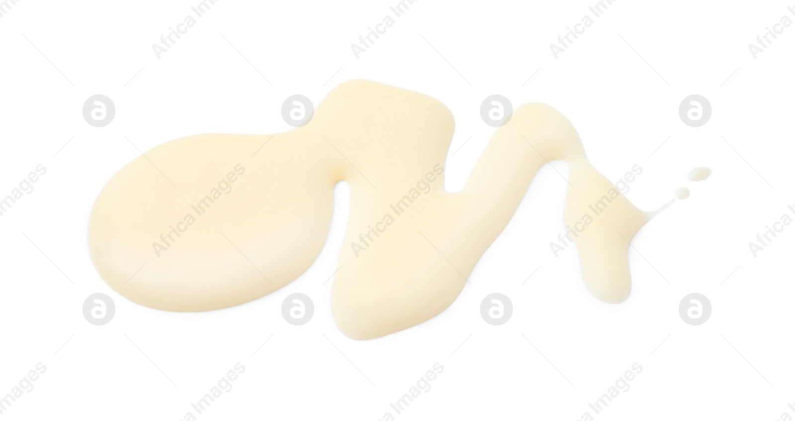 Photo of Spilled tasty condensed milk isolated on white