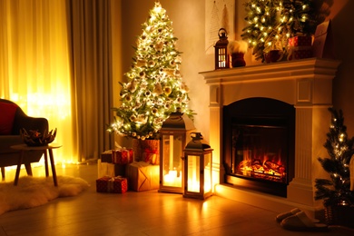 Stylish living room interior with beautiful fireplace, Christmas tree