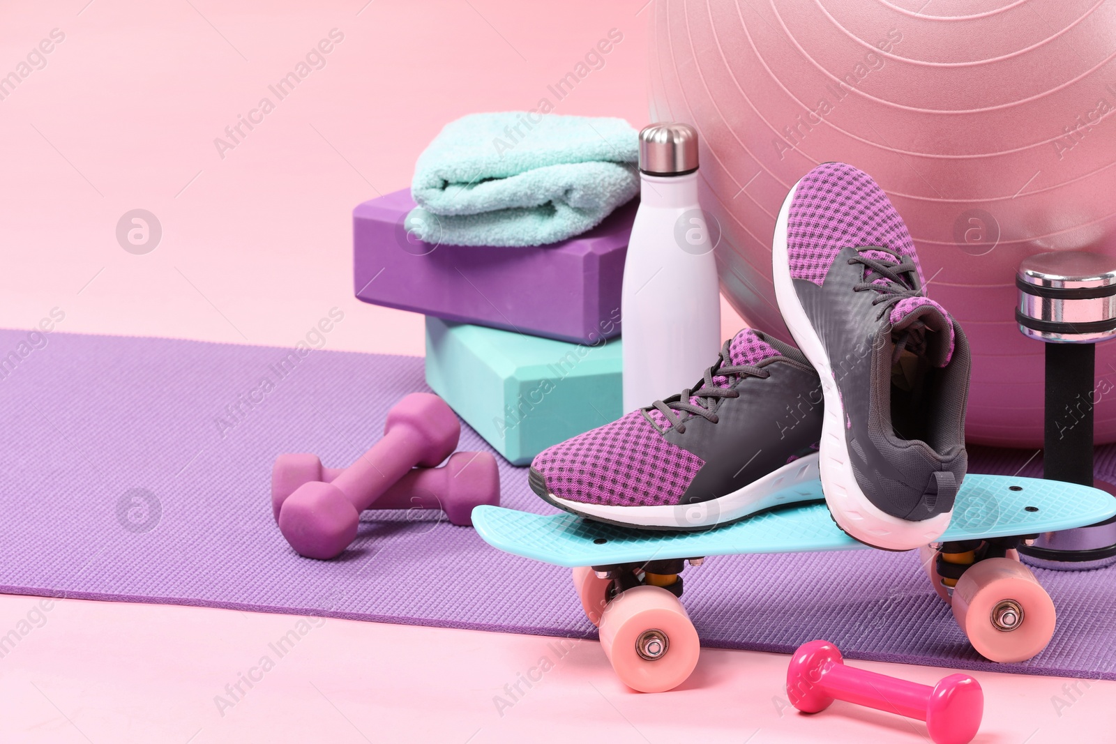 Photo of Many different sports equipment on pink background, space for text