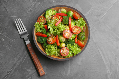 Tasty salad with Brussels sprouts on grey table, top view