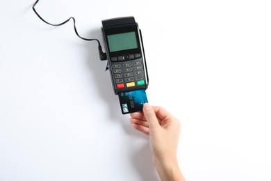 Photo of Woman using modern payment terminal on white background, top view