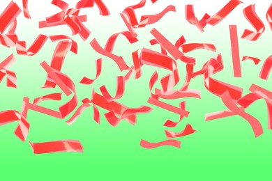 Bright red confetti falling on gradient green background