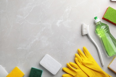 Photo of Flat lay composition with cleaning supplies for dish washing and space for text on grey background