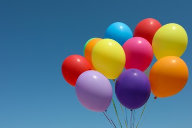 Photo of Bunch of colorful balloons against blue sky