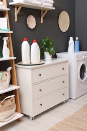 Photo of Laundry room interior with washing machine and furniture