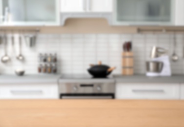 Photo of Countertop and blurred view of kitchen interior on background