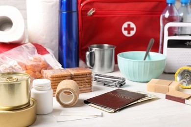 Photo of Disaster supply kit for earthquake on white wooden table