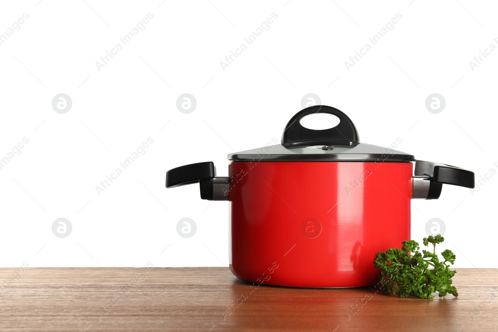 Photo of Clean red saucepan and parsley on table against white background, space for text