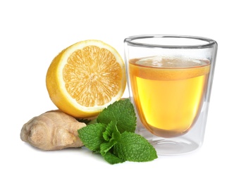 Glass cup with hot ginger tea, mint and lemon on white background