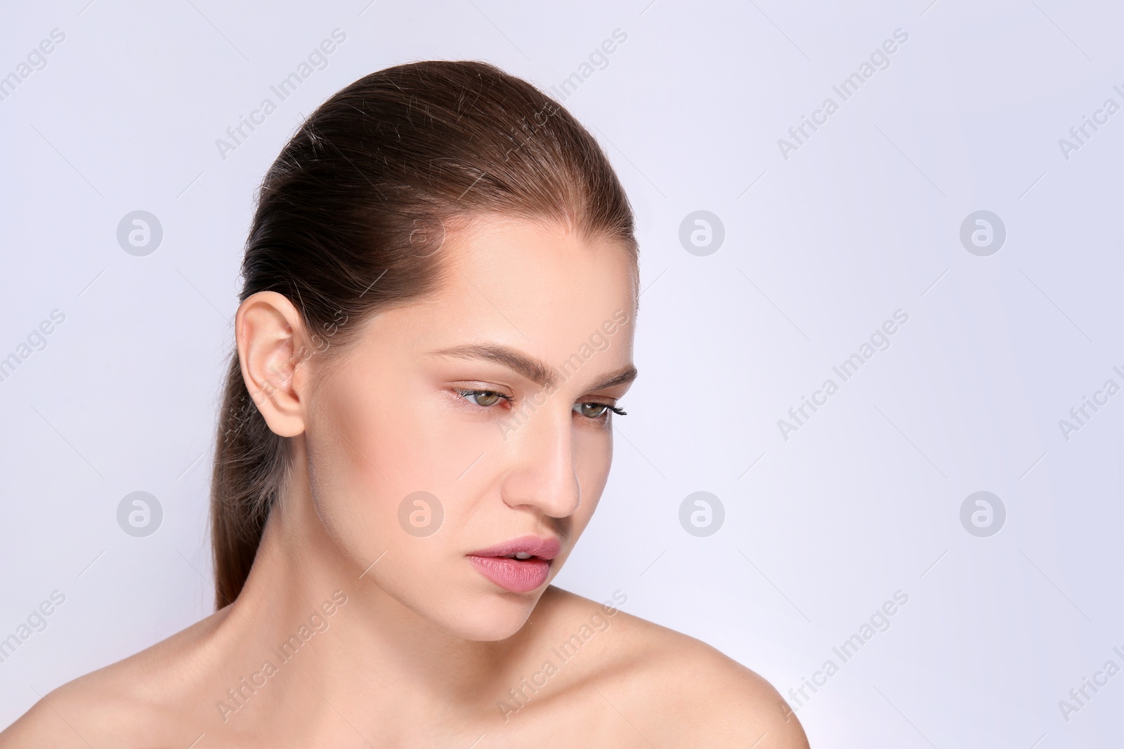 Photo of Beautiful woman with perfect eyebrows on light background