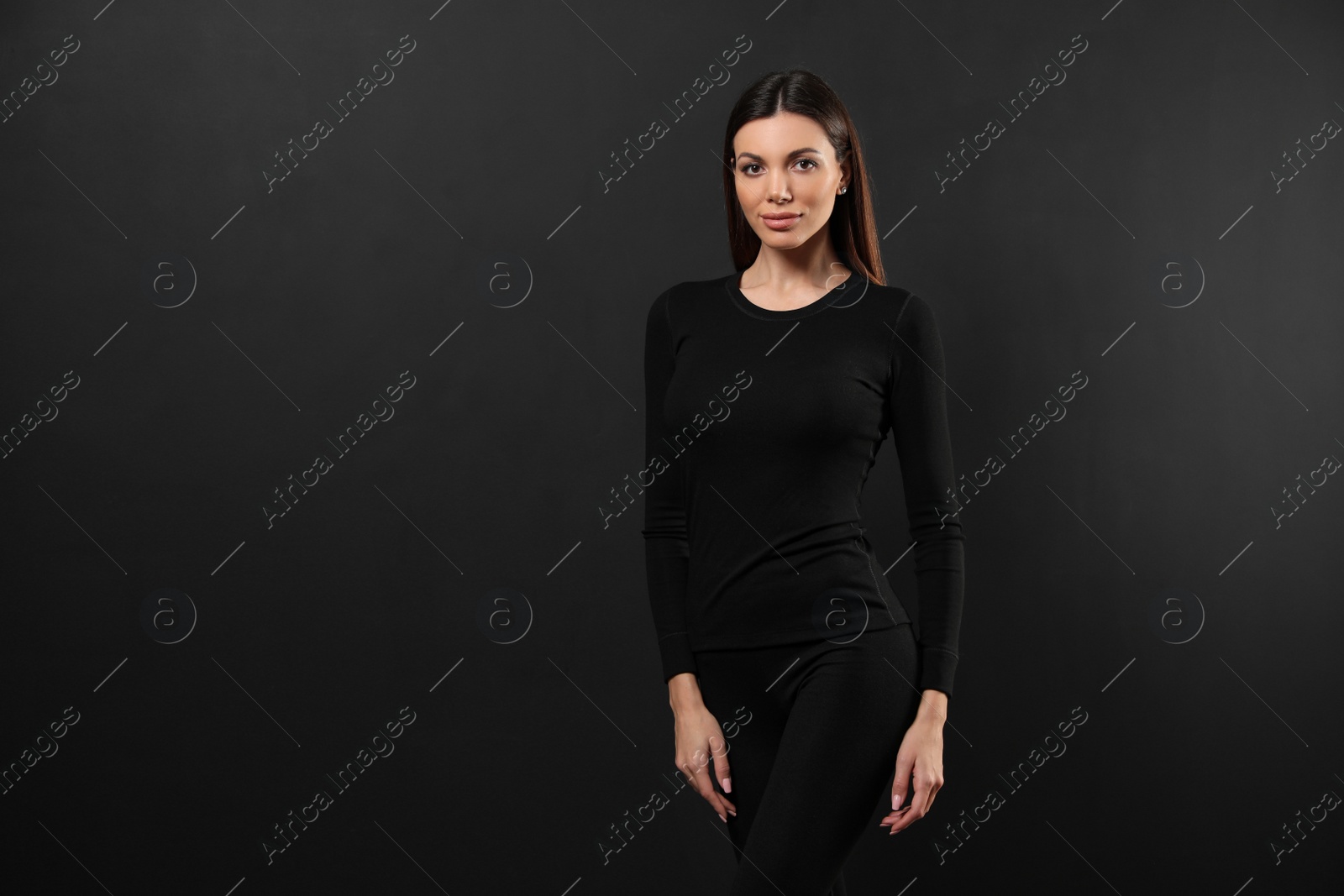 Photo of Woman wearing thermal underwear on black background. Space for text