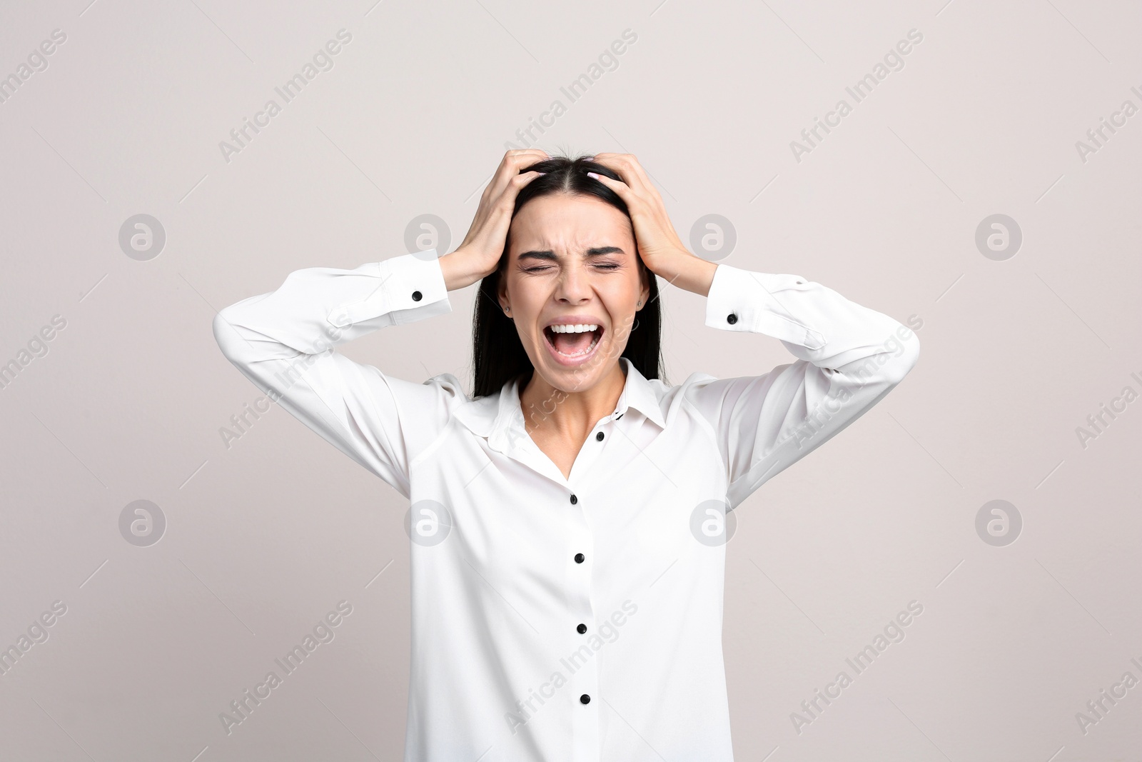 Photo of Portrait of stressed young woman on beige background