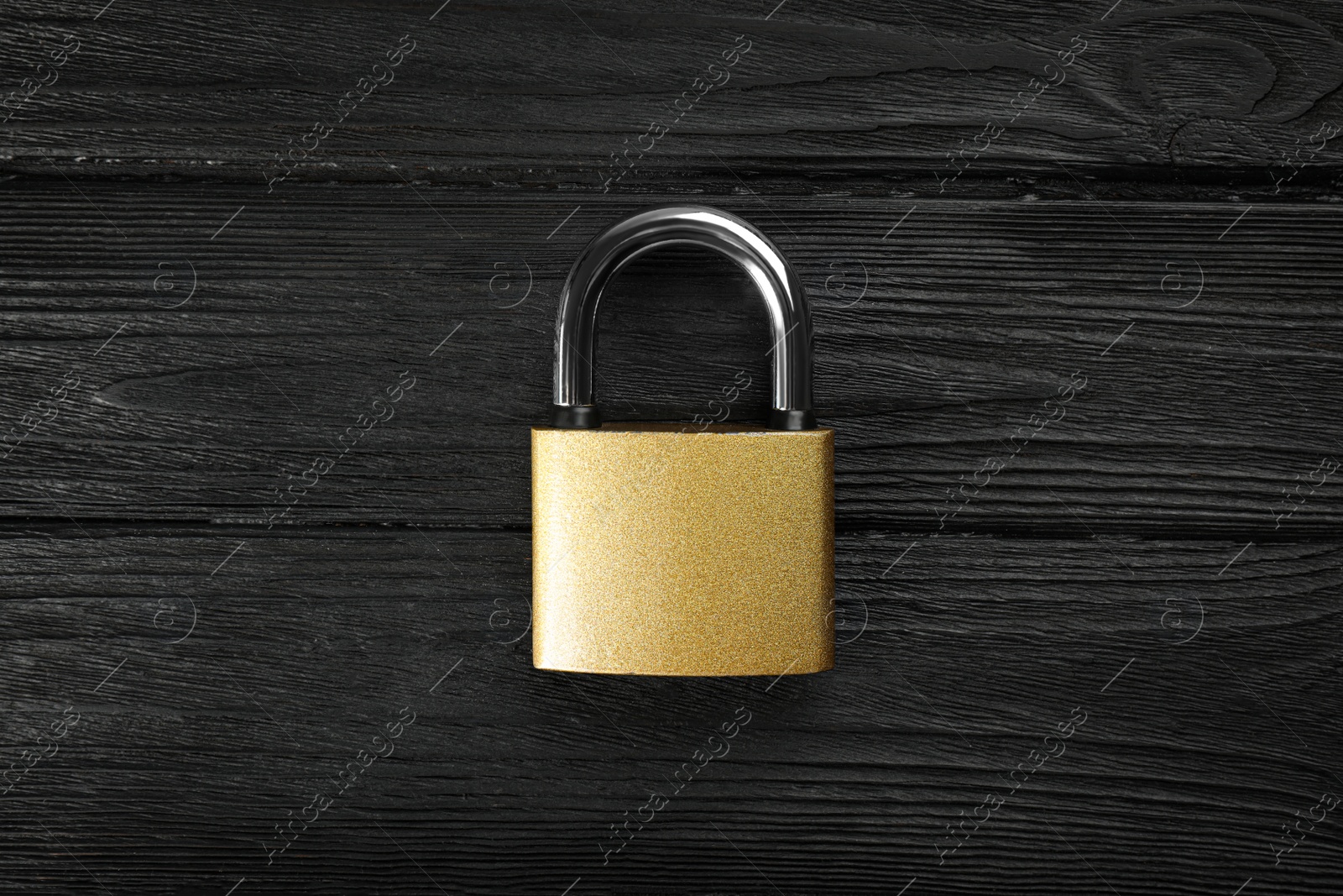 Photo of Modern padlock on black wooden table, top view