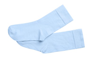 Pair of light blue socks on white background, top view