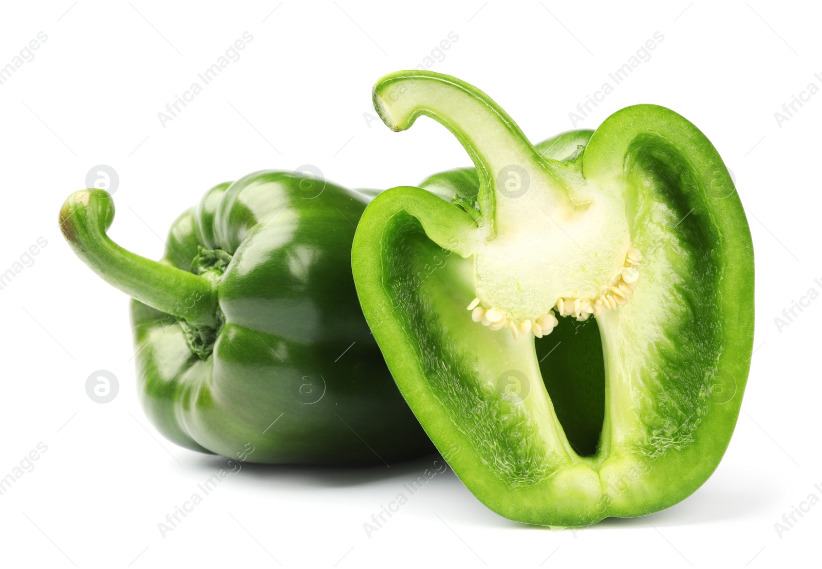 Photo of Cut and whole tasty green bell peppers on white background