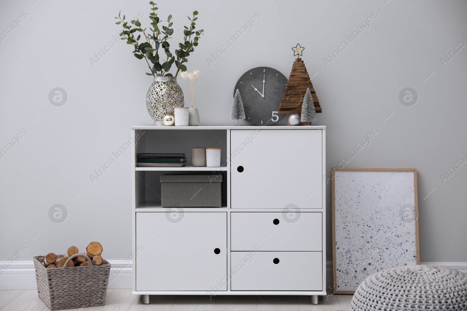 Photo of Modern room interior with white cabinet near light wall