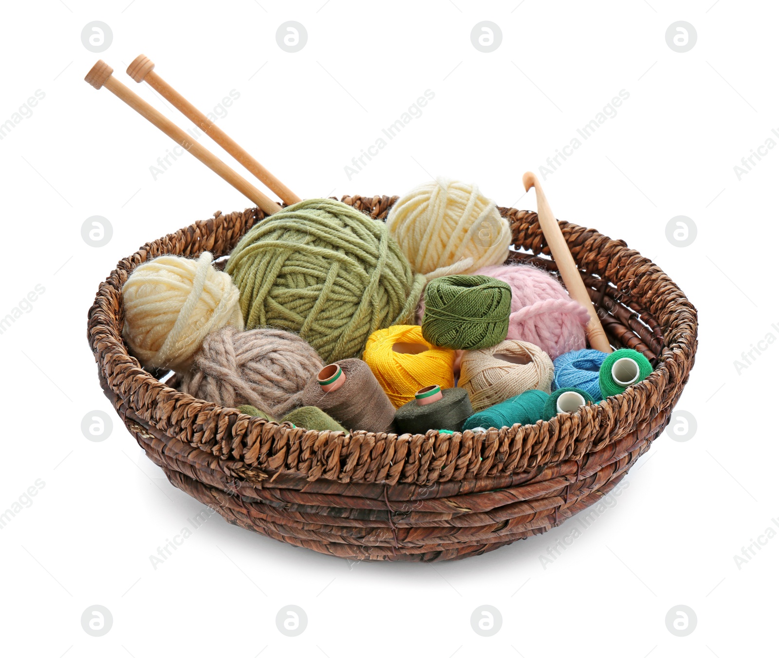 Photo of Basket with set of color threads and needles on white background