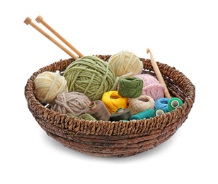 Photo of Basket with set of color threads and needles on white background