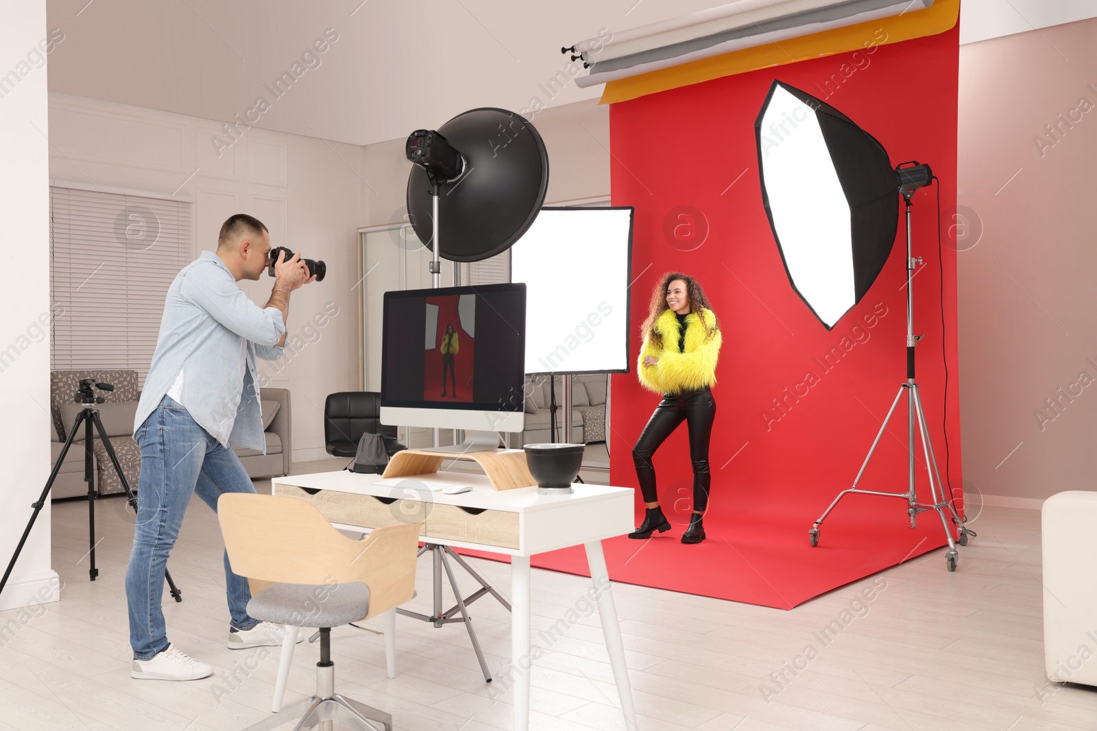 Photo of Beautiful African American model posing for professional photographer in studio