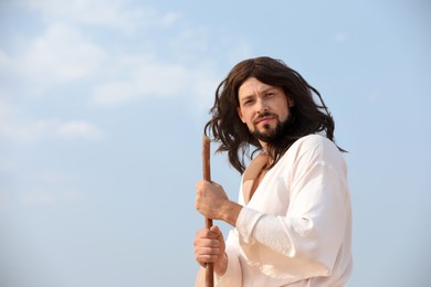 Photo of Jesus Christ with stick against blue sky