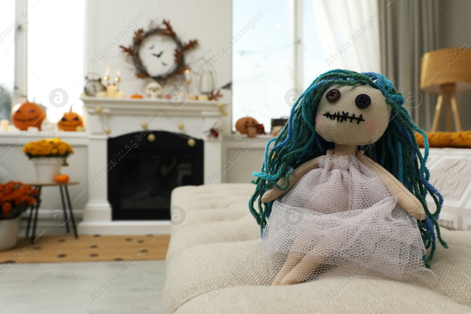 Photo of Spooky doll on sofa in room, space for text. Halloween decor