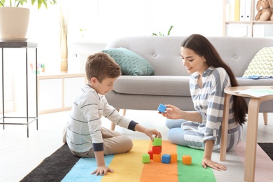 Child psychologist working with boy in office