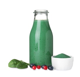 Photo of Bottle of spirulina smoothie, powder and berries on white background