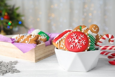 Photo of Bowl with tasty homemade Christmas cookies on table