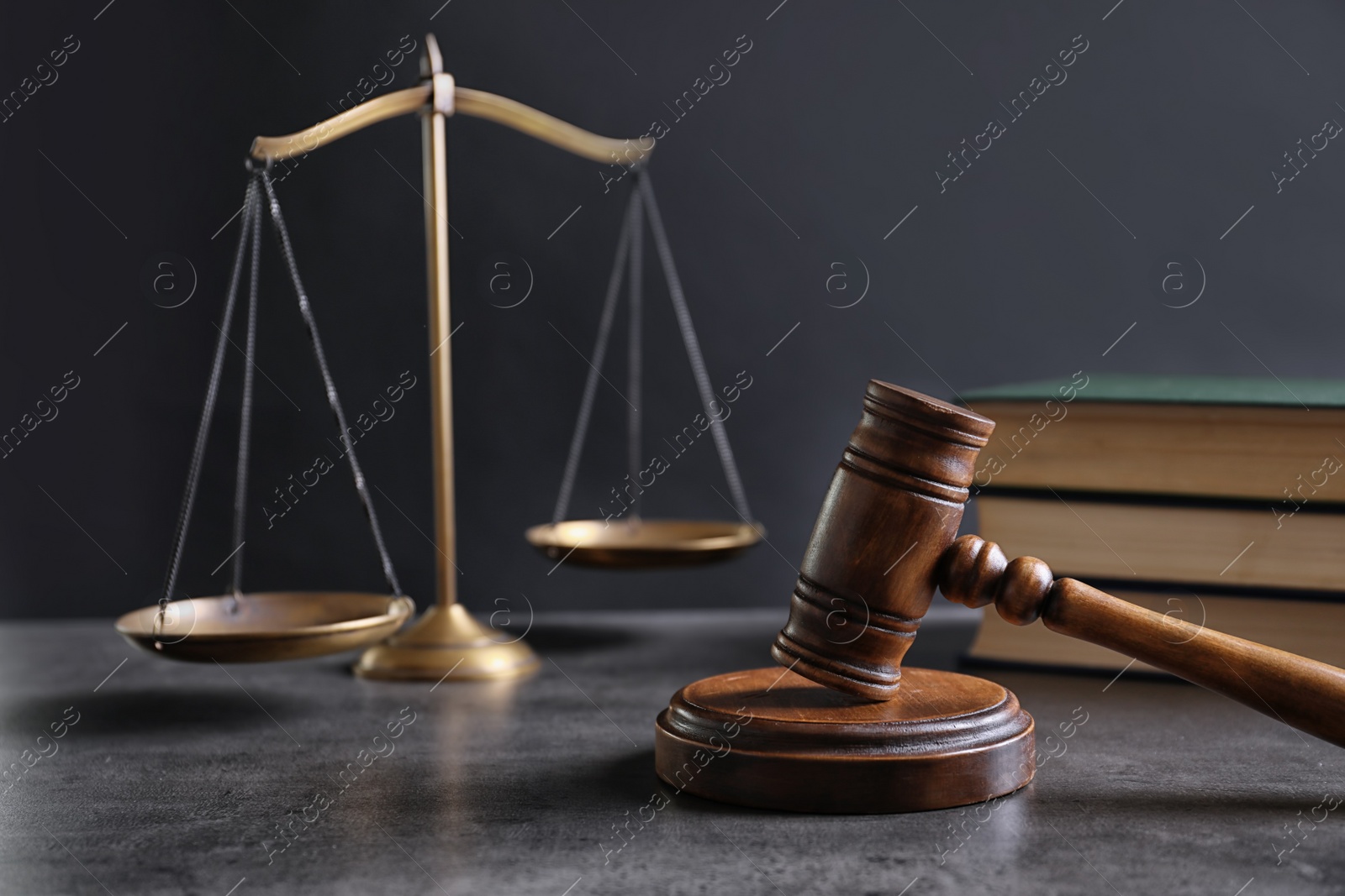 Photo of Judge's gavel and blurred scales on background. Law concept