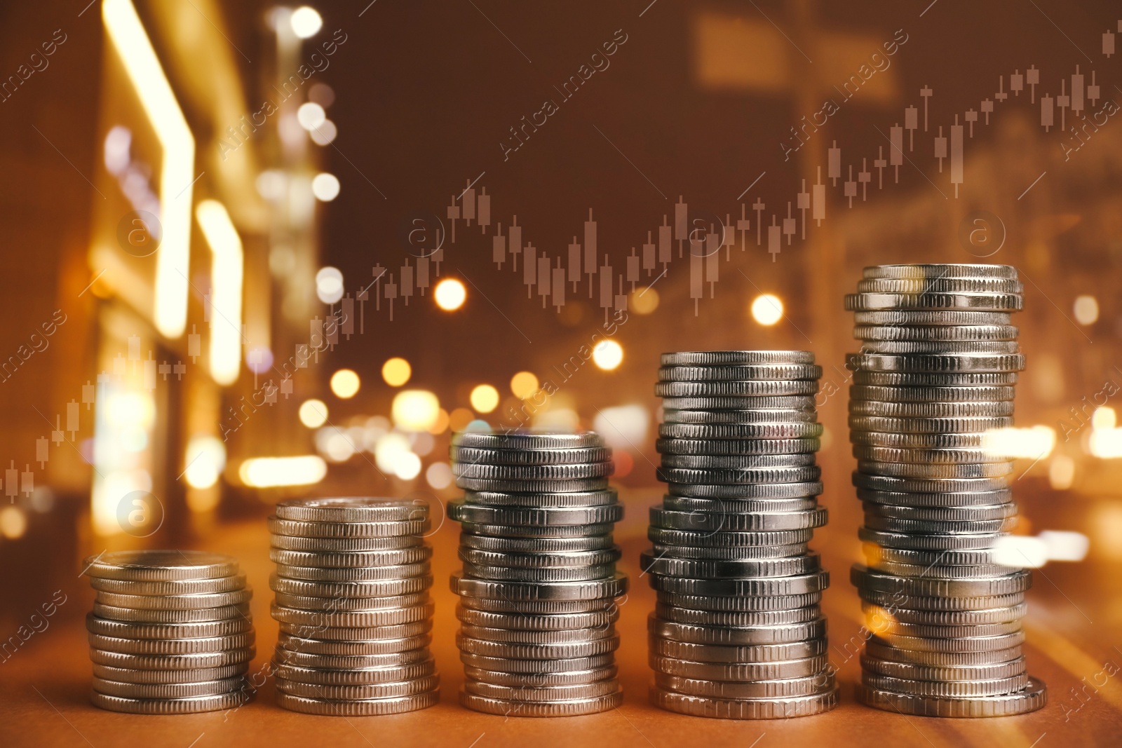 Image of Multiple exposure of stacked coins, charts and night cityscape